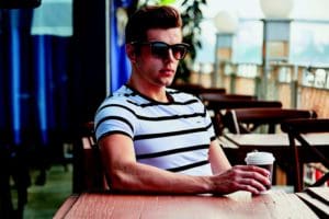 Davis - Handsome male holding a cup of coffee