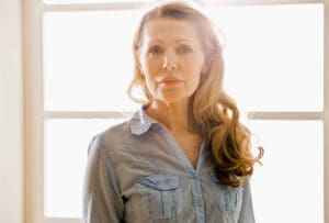 Beautiful older woman standing in the sunlight
