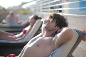 man sitting by a pool