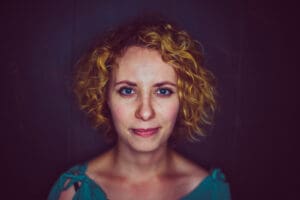 woman in turquoise shirt